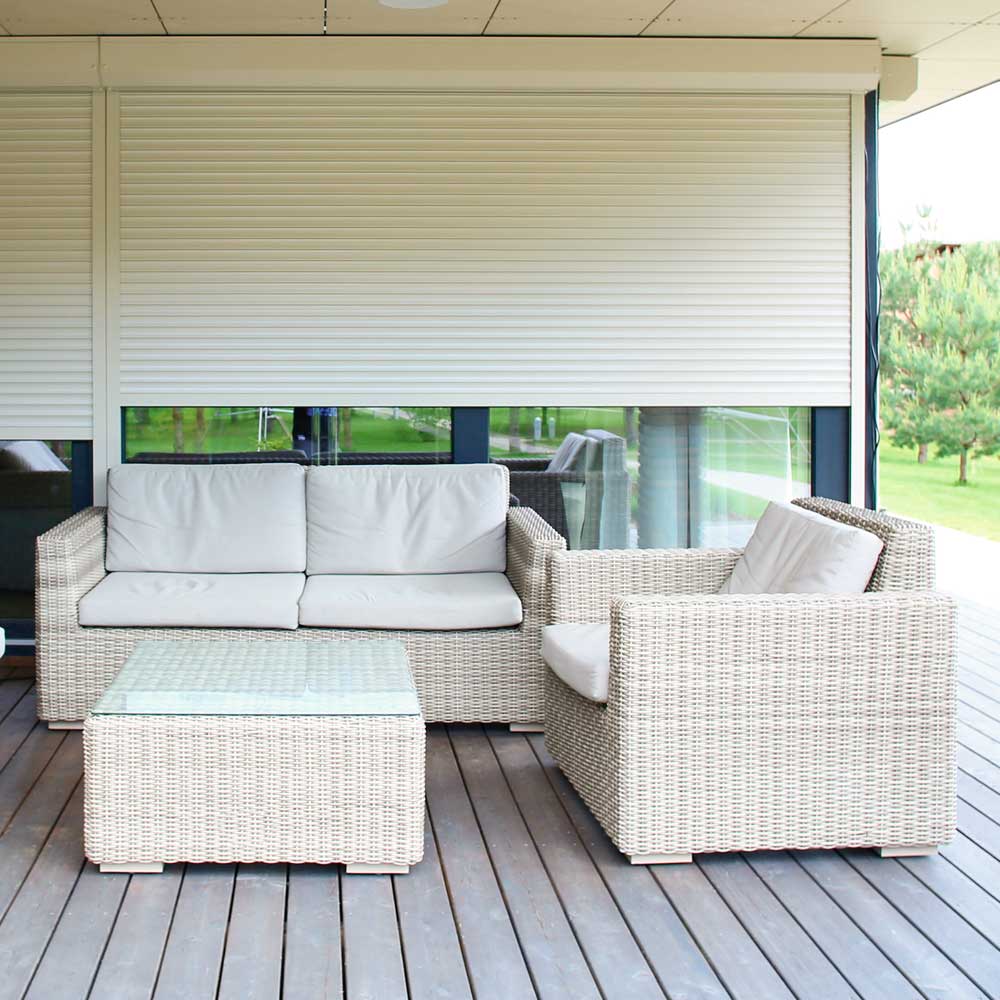 Roll Shutters displayed on a home window with patio furniture